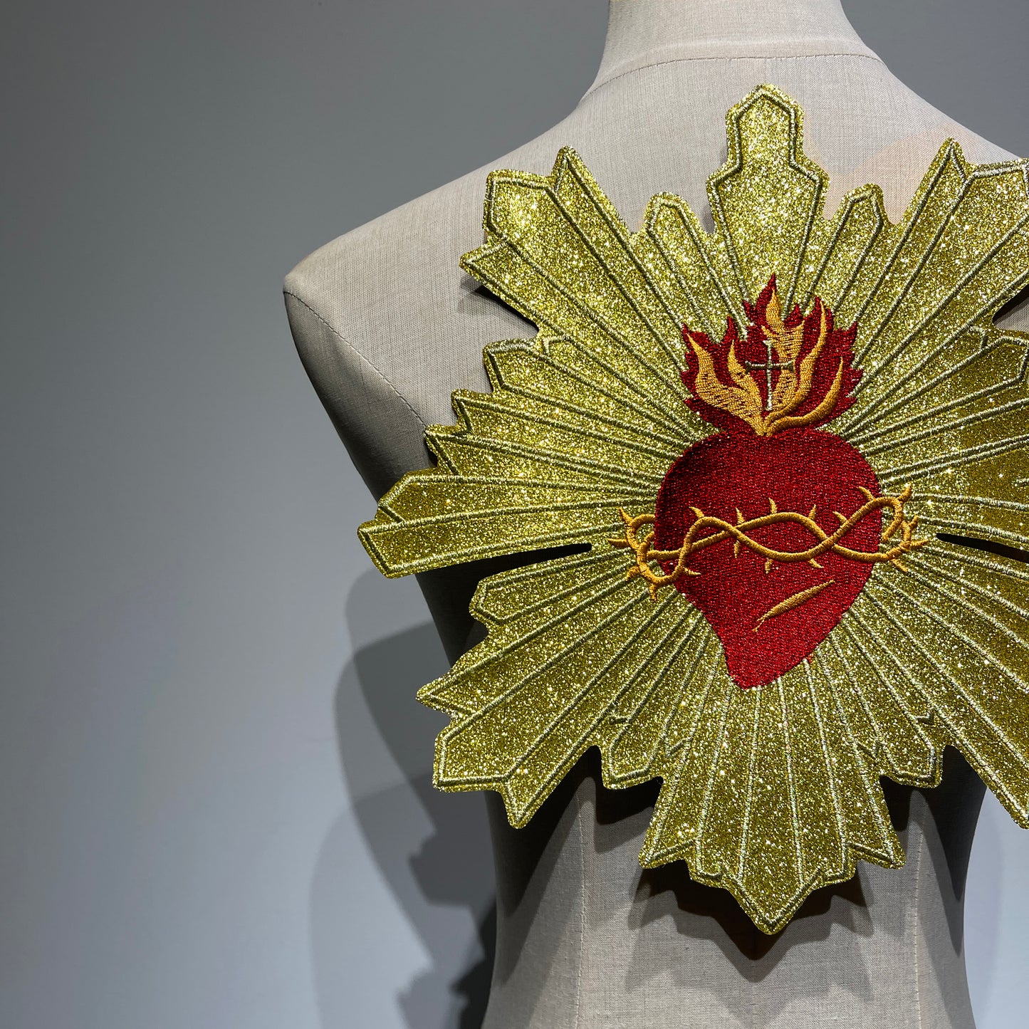 Alternate perspective angle showcasing full-scale gold metallic sunburst embroidery details on sacred heart jacket back patch patchmanstore