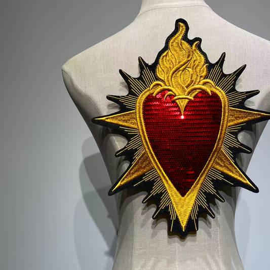 Full centered back view of the Sacred Heart sequin and embroidery patch on a mannequin demonstrating its large scale placement as a jacket backpiece
