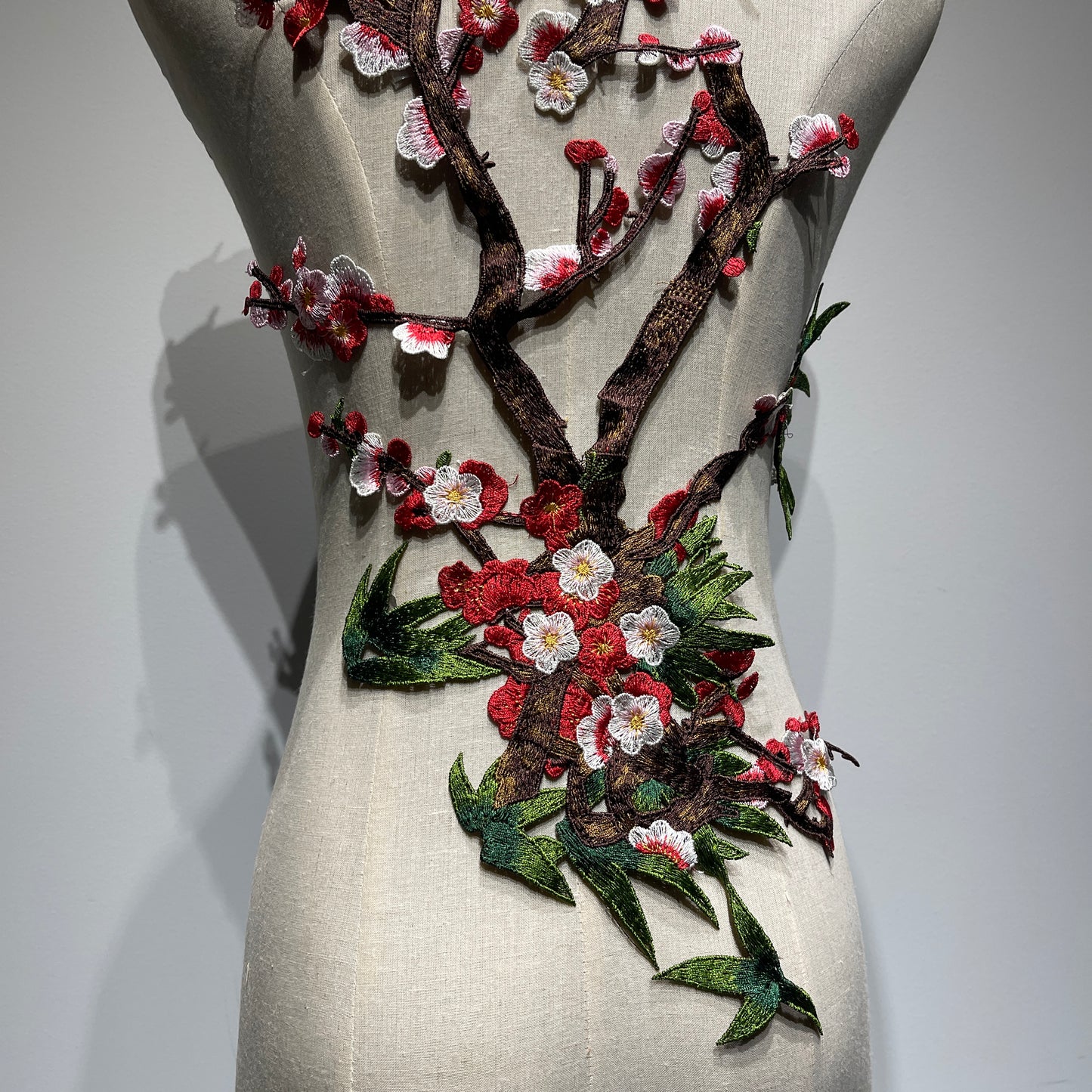 Plum blossom embroidery appliqué with delicate stitching