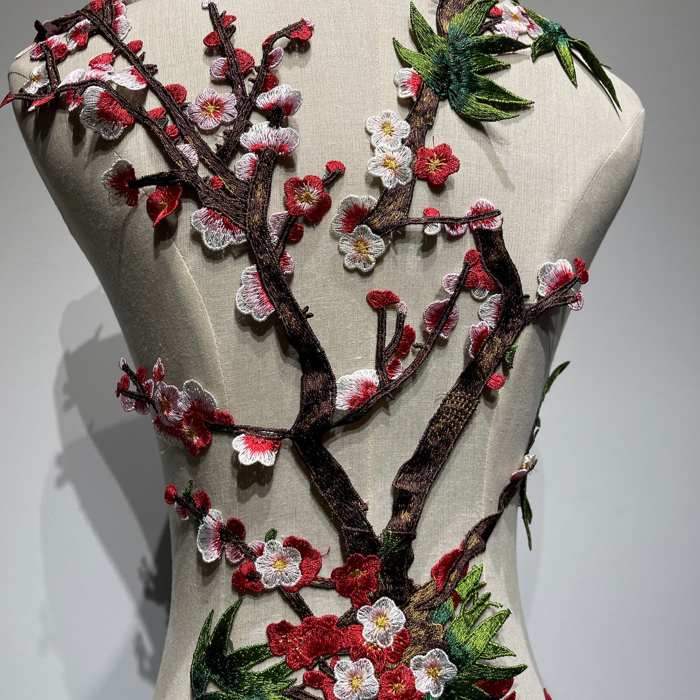 Plum blossom embroidery appliqué with delicate stitching