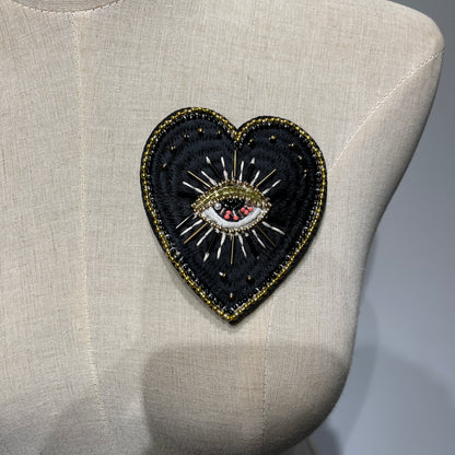 ⁠Mannequin chest displaying a custom luxury handmade black evil eye beaded heart patch - 9x8.5cm.⁠