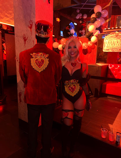 Customer feedback photo showing a couple wearing matching DIY Halloween costumes decorated with the large Sacred Heart crown sequin patches on a red velvet blazer and a corset.⁠