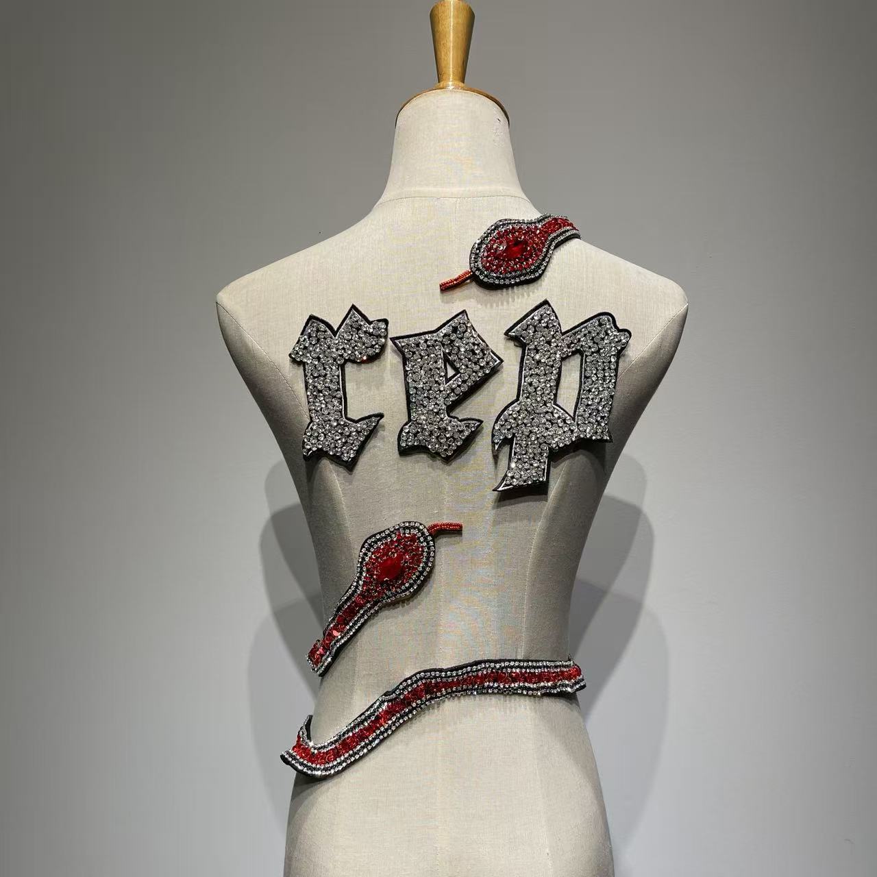 Full set of handcrafted "REP" crystal rhinestone letters and a 3D hand-stitched red and black crystal snake patch for DIY concert jackets.⁠