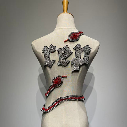 Full set of handcrafted "REP" crystal rhinestone letters and a 3D hand-stitched red and black crystal snake patch for DIY concert jackets.⁠