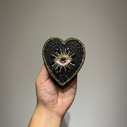 Handmade black evil eye beaded heart patch featuring gothic gold embroidery, faux pearls, and seed beads for DIY fashion - 9x8.5cm.⁠