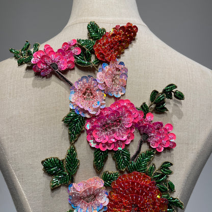 An ultra-close-up of the haute couture embroidery and beadwork, showing high-luster pink sequins, glass bugle beads on green leaves, and premium craftsmanship textures.⁠