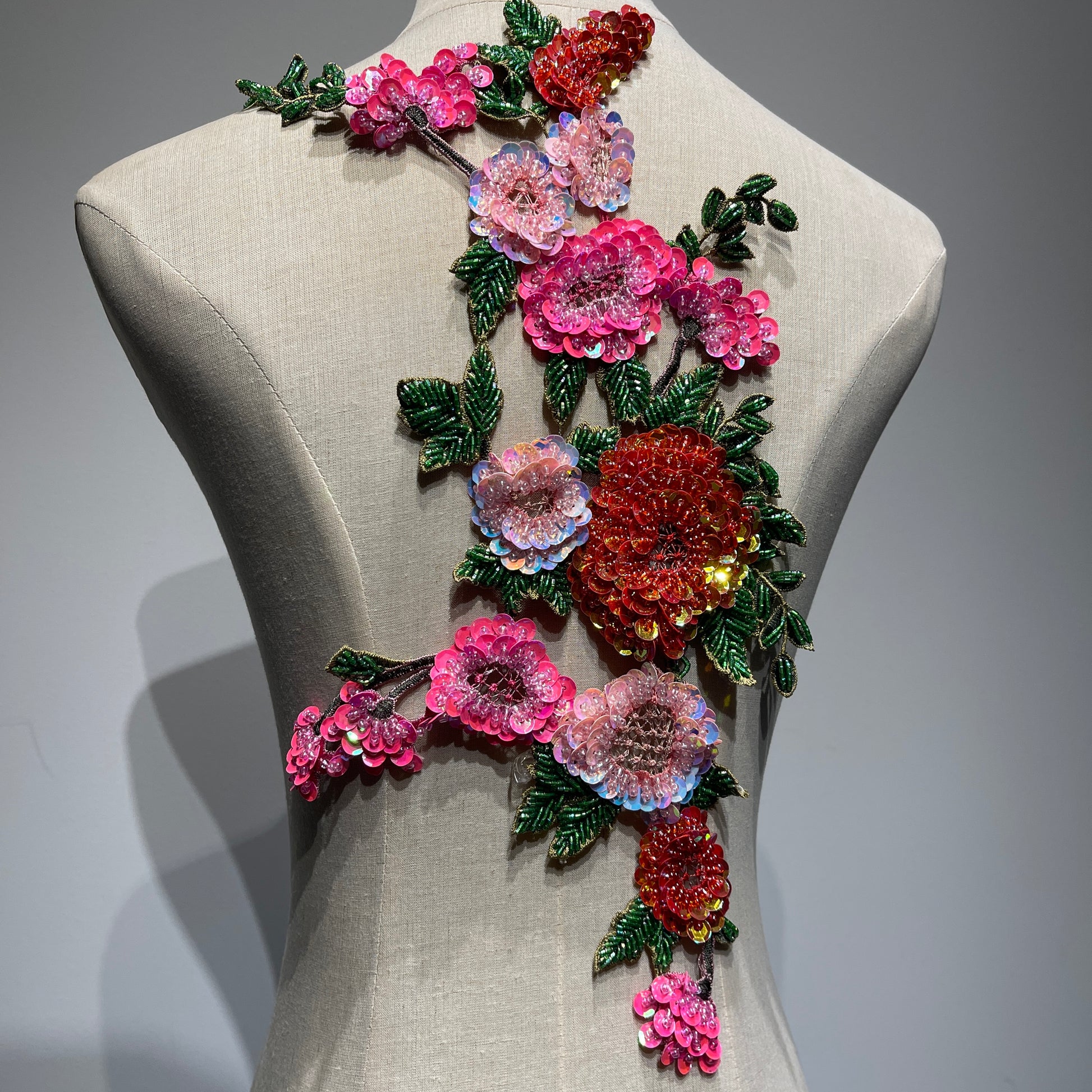 Full-length view of the 39.5cm large beaded floral embroidery patch displayed on a studio mannequin, showcasing the rich vertical flow and vibrant pink and red flower placement.⁠