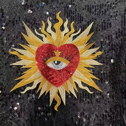 Vibrant baroque red sacred heart sequin patch styled on a black glistening sequin jacket background, luxury custom festival outfit and concert clothing wear styling ideas