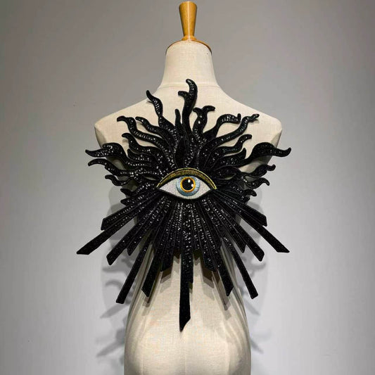Oversized luxury black and gold evil eye sequin patch on a mannequin, handcrafted large embroidery back patch for jacket DIY custom fashion.