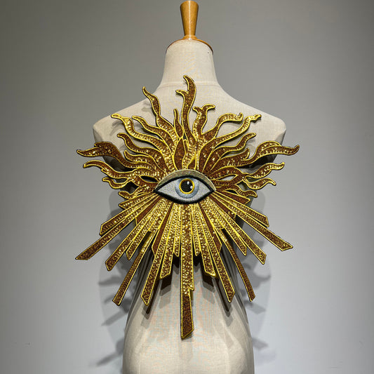 Oversized luxury metallic golden evil eye sequin patch on a mannequin, handcrafted large gold sunburst embroidery back patch for jacket DIY fashion.