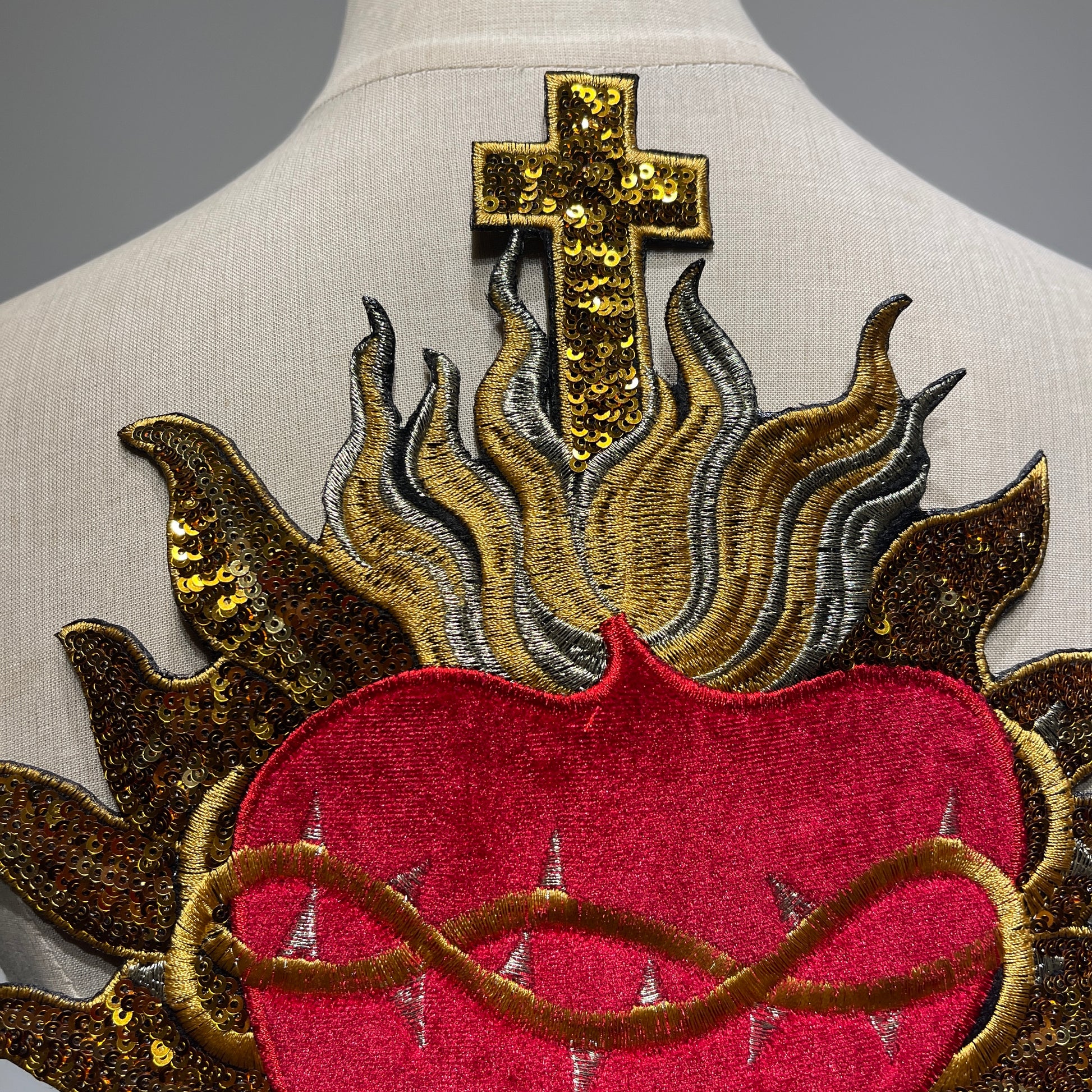 Close-up craftsmanship details of luxury red velvet and metallic gold sequins on sacred heart embroidered patch patchmanstore
